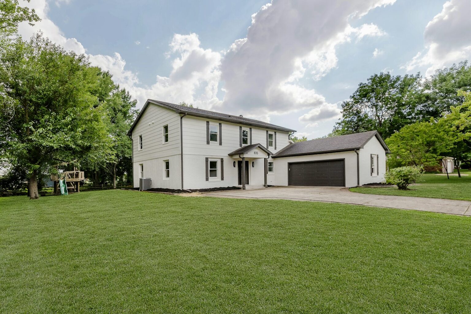 White two-story home with garage